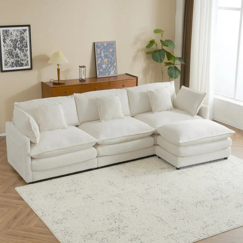 Canapé d'angle avec pouf amovible, en velours côtelé, en forme de L, à assise profonde, avec coussins lombaires et poches latérales.