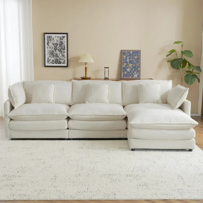 Canapé d'angle avec pouf amovible, en velours côtelé, en forme de L, à assise profonde, avec coussins lombaires et poches latérales.