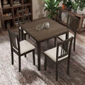 Ensemble table et chaises pour coin repas dans la cuisine : table carrée en bois avec 4 chaises rembourrées.
