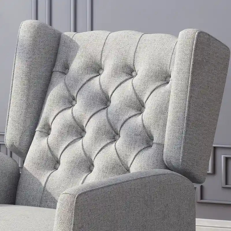 Fauteuil inclinable à oreilles de style mid-century, revêtu de tissu gris, avec repose-pieds et dossier capitonné.