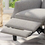 Fauteuil inclinable à oreilles de style mid-century, revêtu de tissu gris, avec repose-pieds et dossier capitonné.